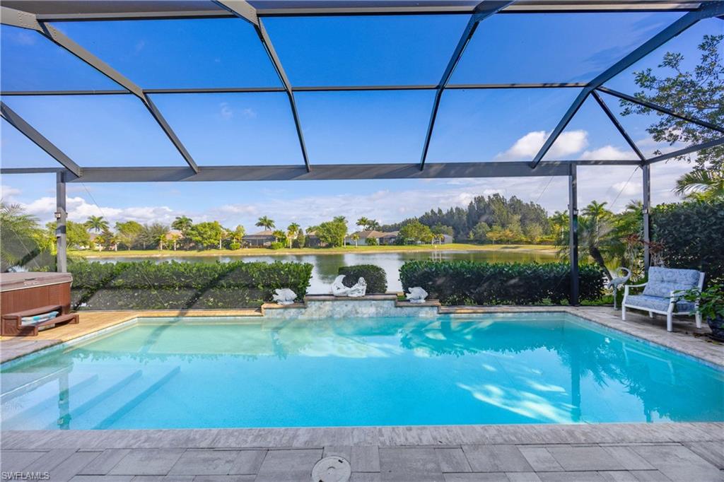 14748 Windward Lane Naples, FL 34114 - Photo 29 of 47 a view of a swimming pool and lounge chairs in back yard of the house
