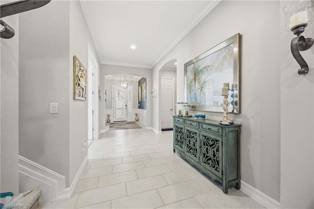 14748 Windward Lane Naples, FL 34114 - Photo 3 of 47 a bathroom with a granite countertop sink a mirror and a shower