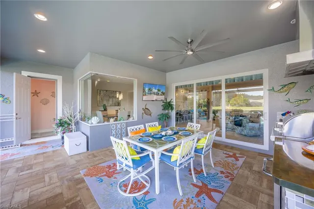 a dining room with furniture a floor to ceiling window and potted plants