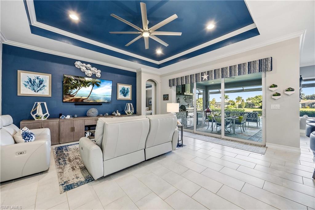 14748 Windward Lane Naples, FL 34114 - Photo 4 of 47 a living room with furniture a ceiling fan and a large window