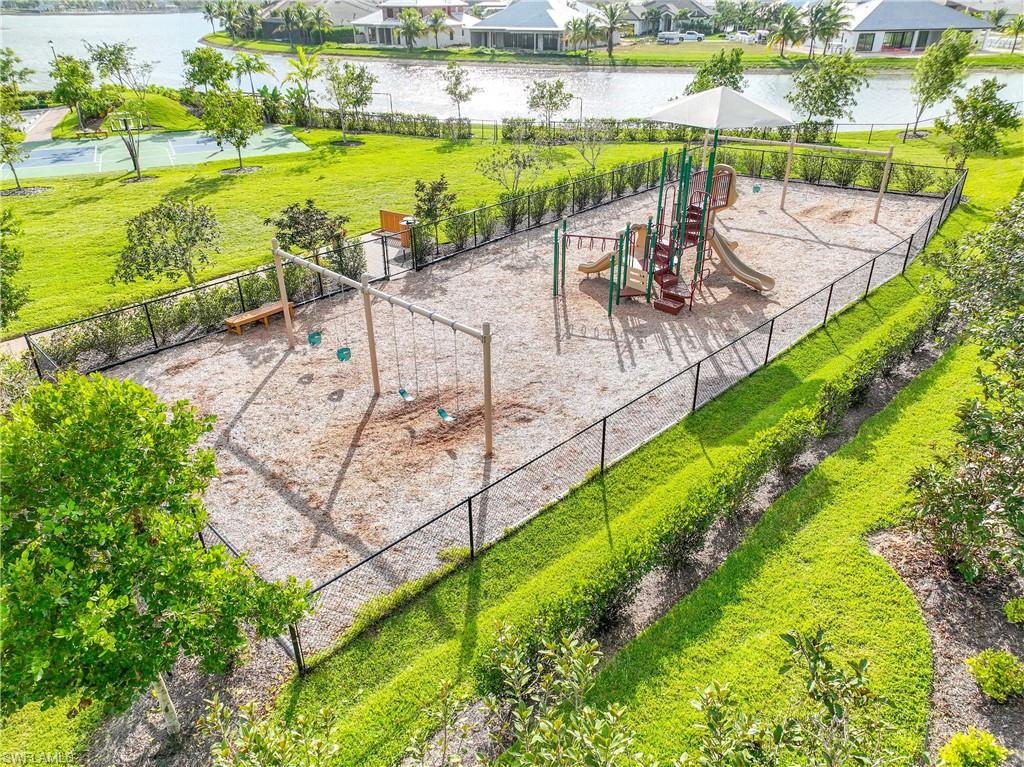 14748 Windward Lane Naples, FL 34114 - Photo 44 of 47 a view of swimming pool with outdoor seating and lake