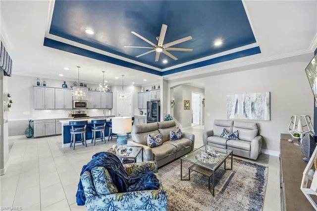 a living room with furniture and kitchen view