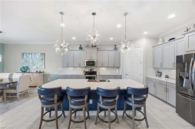 a large kitchen with a table and chairs