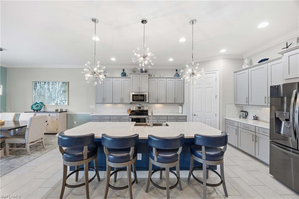 14748 Windward Lane Naples, FL 34114 - Photo 8 of 47 a large kitchen with a table and chairs