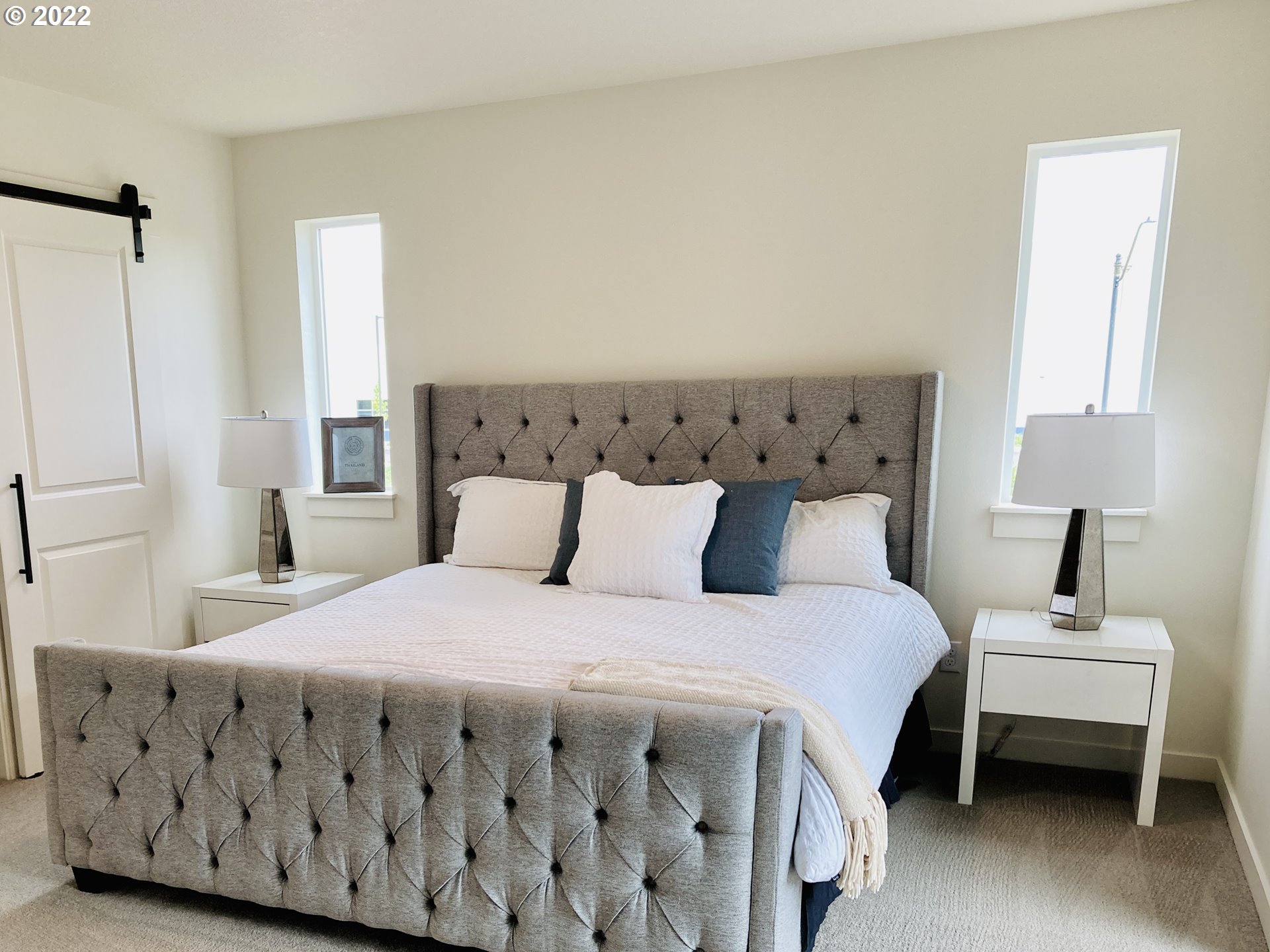 7138 South 11th Street Ridgefield, WA 98642 - Photo 9 of 14 a bedroom with a bed table and a window