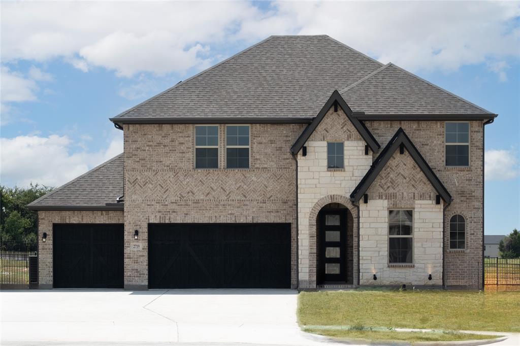 2719 Triumph Court Heath, TX 75126 - Photo 37 of 39 a front view of a house with a garden