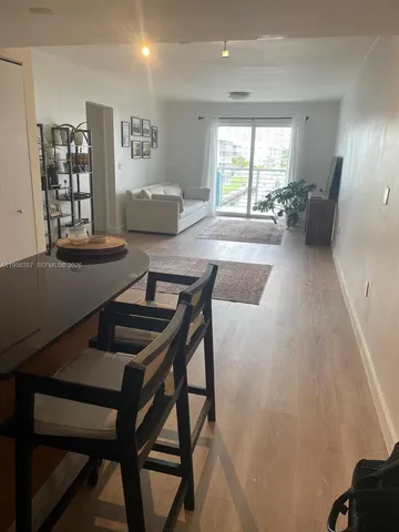 a view of a dining room with furniture and window