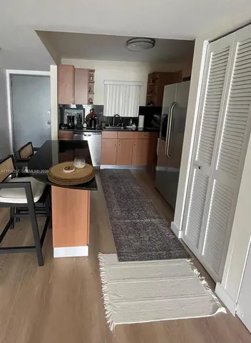 a kitchen with stainless steel appliances granite countertop a refrigerator stove and sink