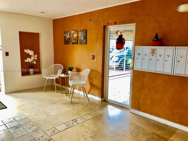 a dining room with wooden floor and furniture