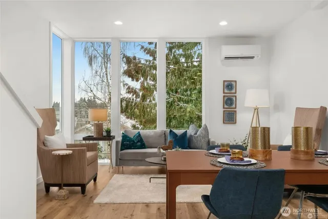 a living room with fireplace furniture and a large window