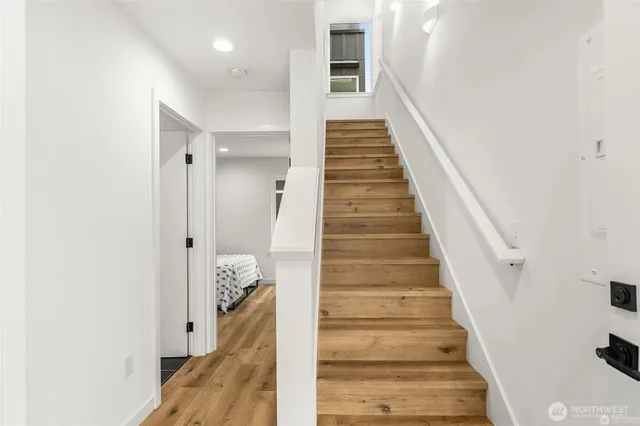 a view of a hallway with wooden floor and entryway
