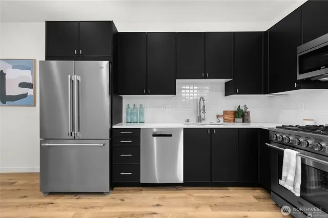 a kitchen with a refrigerator and a stove