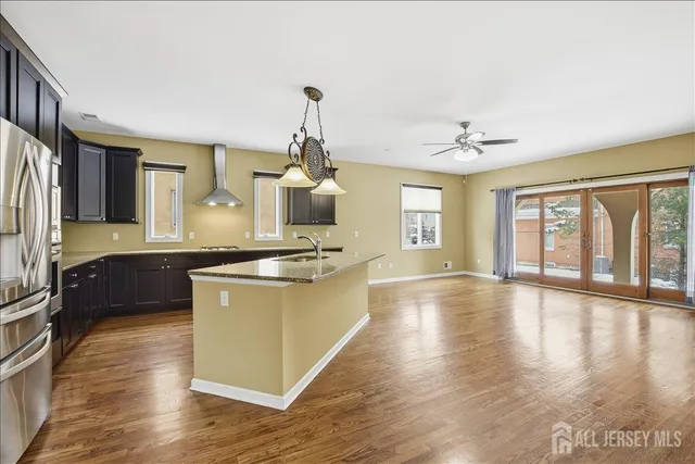 a kitchen with stainless steel appliances kitchen island a large counter space a sink and appliances