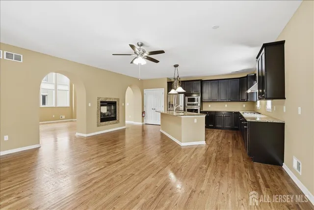 a view of a room with wooden floor and windows