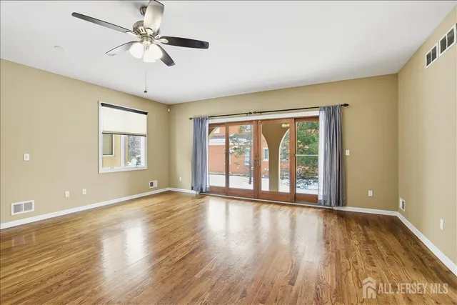 a view of a hallway with wooden floor and windows