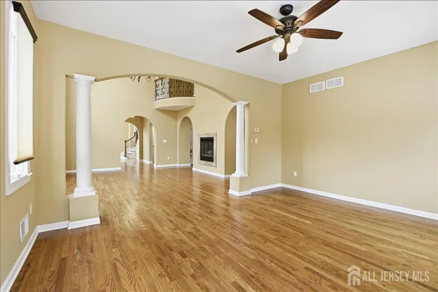 a large kitchen with kitchen island a sink wooden floor and glass doors
