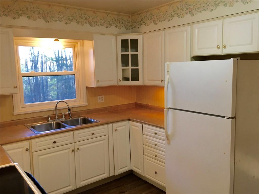 582 Weaver Mill Road Rector, PA 15677 - Photo 14 of 25 A reverse view into the Kitchen coming from the hallway on the opposite side of the Living Room. Matching Curio Doors and Lazy Susan lower cabinets! Again, check out those trees in the back yard!