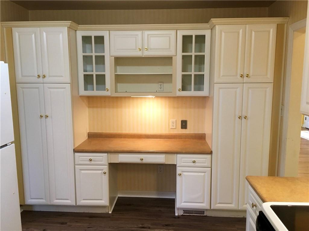 582 Weaver Mill Road Rector, PA 15677 - Photo 15 of 25 How about this desk area flanked by two pantries? Under-cabinet lighting provides a perfect workplace from a laptop. There is much utility here! New flooring. Move right in!