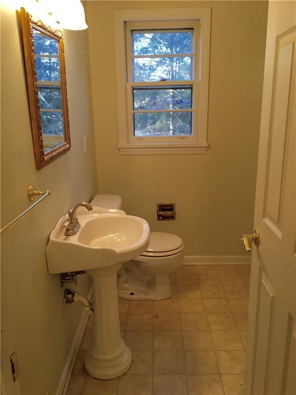 582 Weaver Mill Road Rector, PA 15677 - Photo 17 of 25 Please excuse the photographer, a terrible photo, but this 1/2 Bath is entered into from the main hallway. This is great for guests to use keeping the En-Suite full Bathroom private. It also houses a large 3x6 closet we have called the Laundry Area. (off to the right - out of view). The owner chose to make it a first floor laundry area removing the tub/shower. However it could easily be converted back to a full Bath.