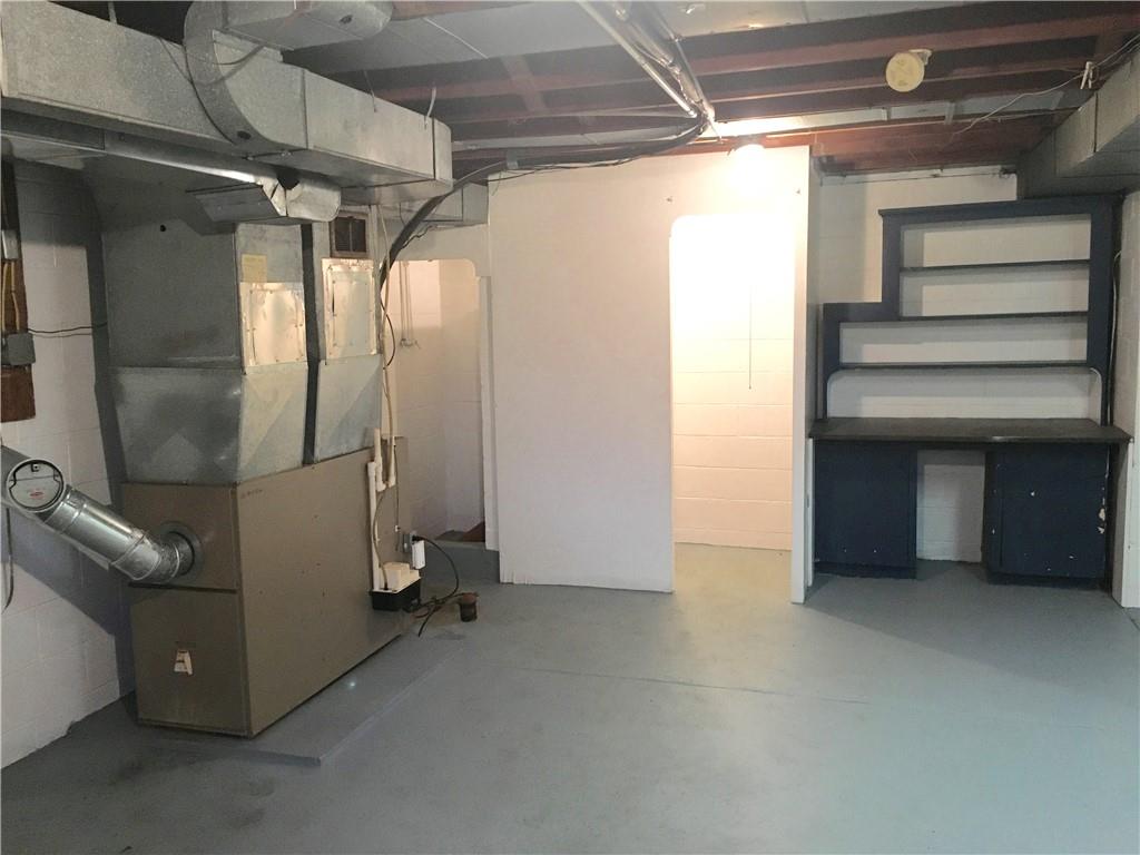 582 Weaver Mill Road Rector, PA 15677 - Photo 25 of 25 This additional room is 17x21! It houses a built-in Desk area, the furnace, Well Pump, Culligan Water Treatment System & the 200 Amp Electrical Panel. The two open doorways in the back are very purposeful; one to a toilet, and the left door to a fully enclosed shower. With some work, this could become a full Bathroom and a somewhat finished off space with good planning.