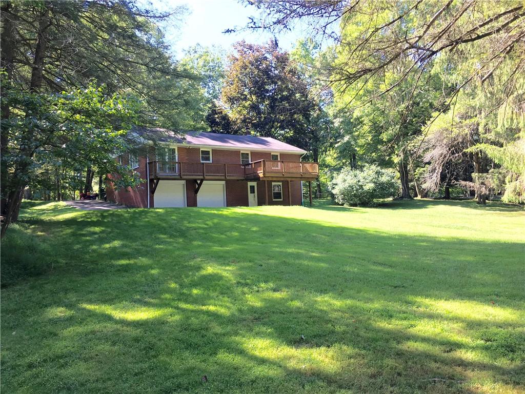 582 Weaver Mill Road Rector, PA 15677 - Photo 7 of 25 A distant shot from the back yard towards the house to show the terrain and trees.