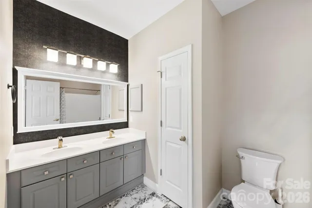a bathroom with a double vanity sink and mirror