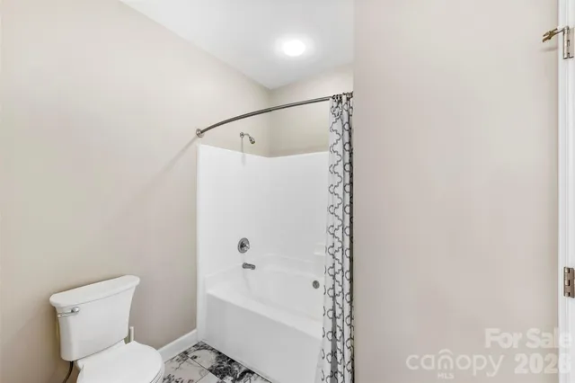 a bathroom with a toilet and a bathtub