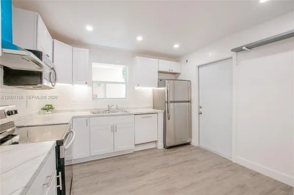 a kitchen with refrigerator cabinets and furniture