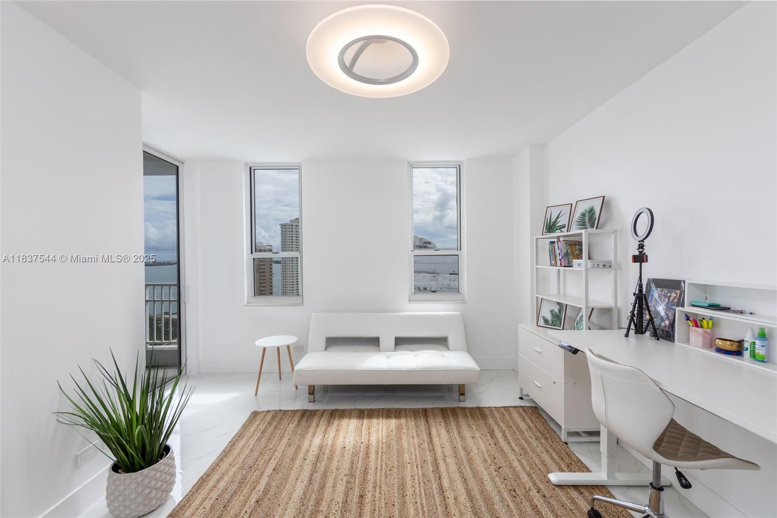 701 Brickell Key Boulevard, Unit 2011 Miami, FL 33131 - Photo 14 of 24 a view of a workspace with furniture and a potted plant