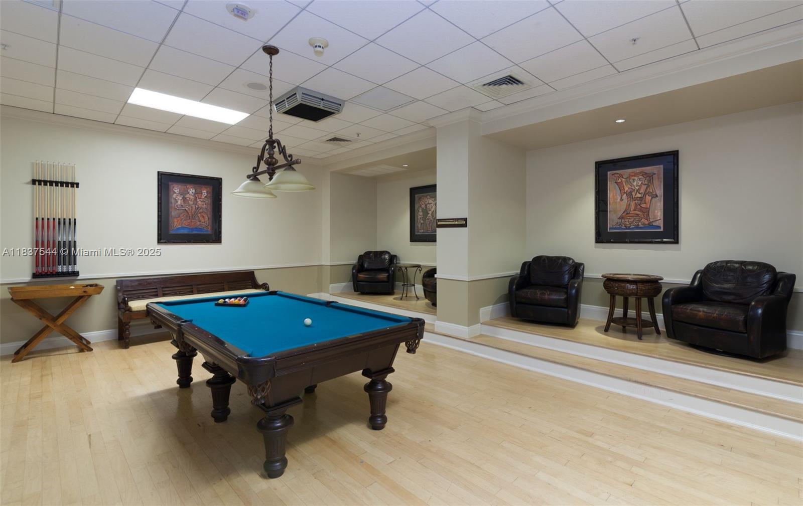 701 Brickell Key Boulevard, Unit 2011 Miami, FL 33131 - Photo 22 of 24 a living room with furniture a table and a flat screen tv