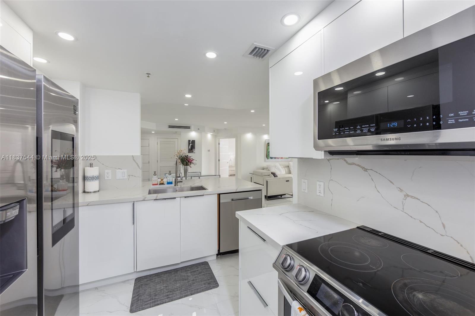701 Brickell Key Boulevard, Unit 2011 Miami, FL 33131 - Photo 6 of 24 a kitchen with a stove and a microwave