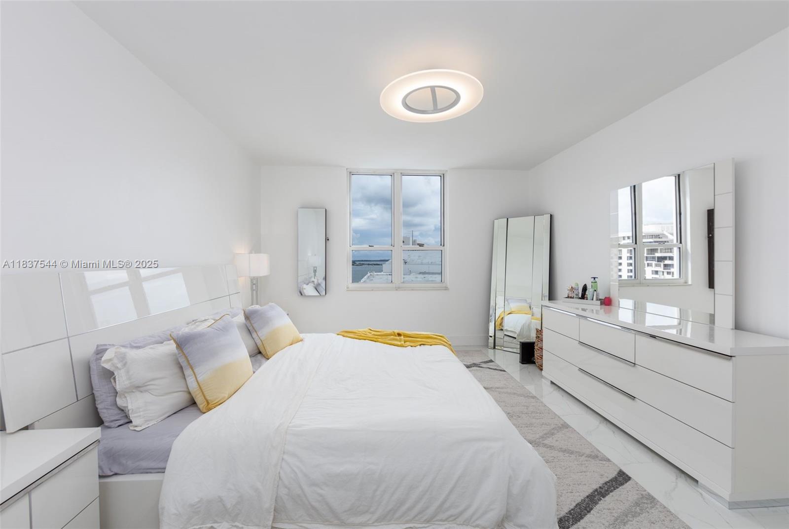 701 Brickell Key Boulevard, Unit 2011 Miami, FL 33131 - Photo 8 of 24 a bedroom with a bed and a large window