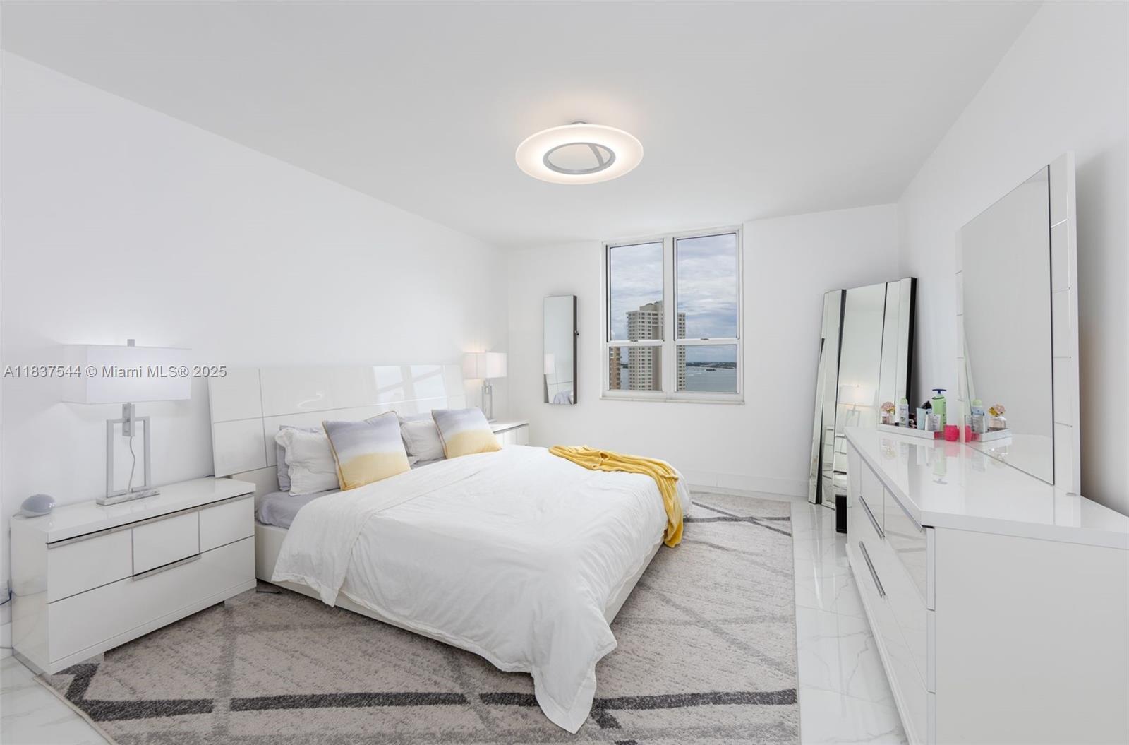 701 Brickell Key Boulevard, Unit 2011 Miami, FL 33131 - Photo 9 of 24 a bedroom with a bed and a large window