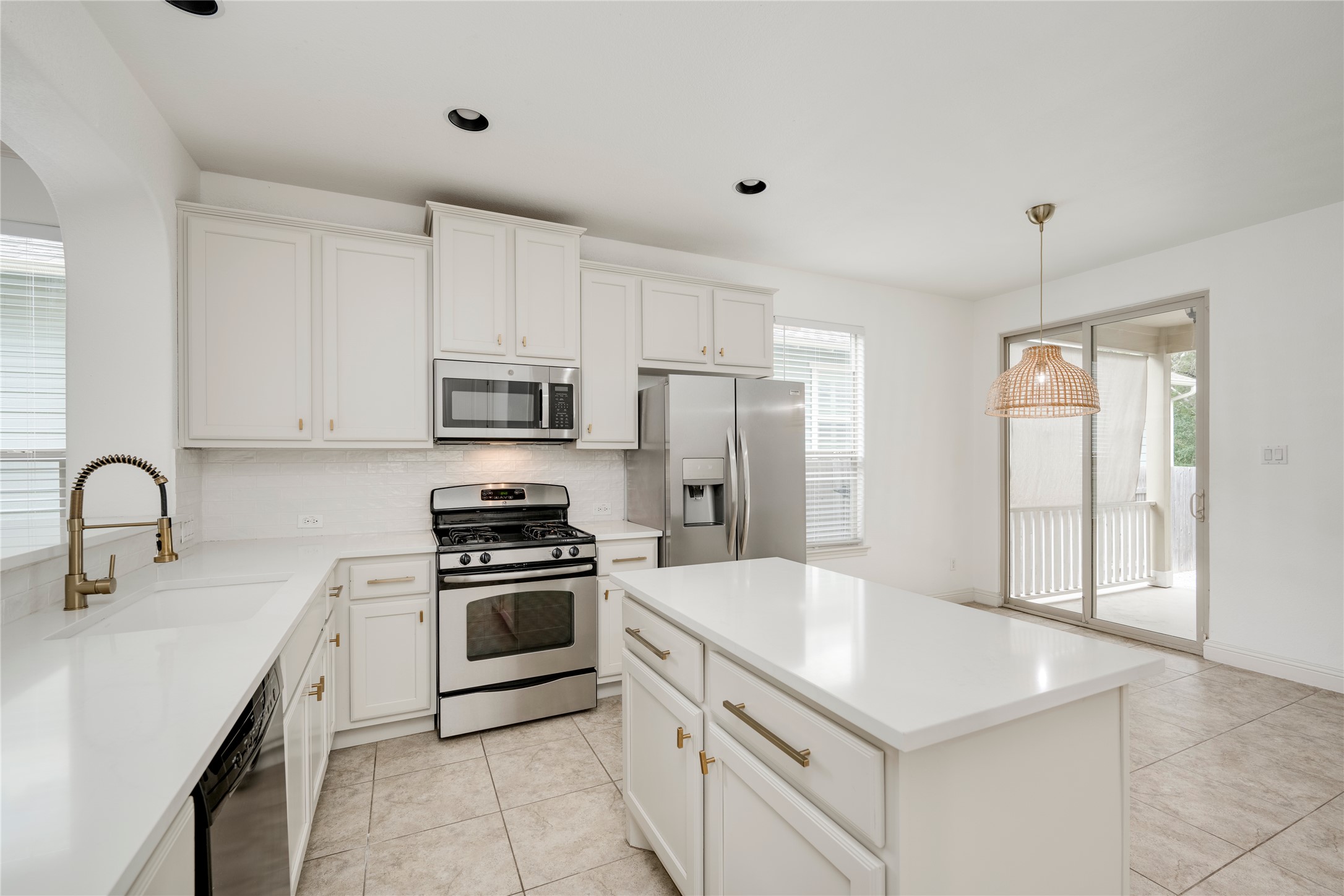 6008 Whipple Way Austin, TX 78745 - Photo 10 of 39 A well-lit kitchen with sleek white cabinetry, stainless steel appliances, and an inviting center island.
