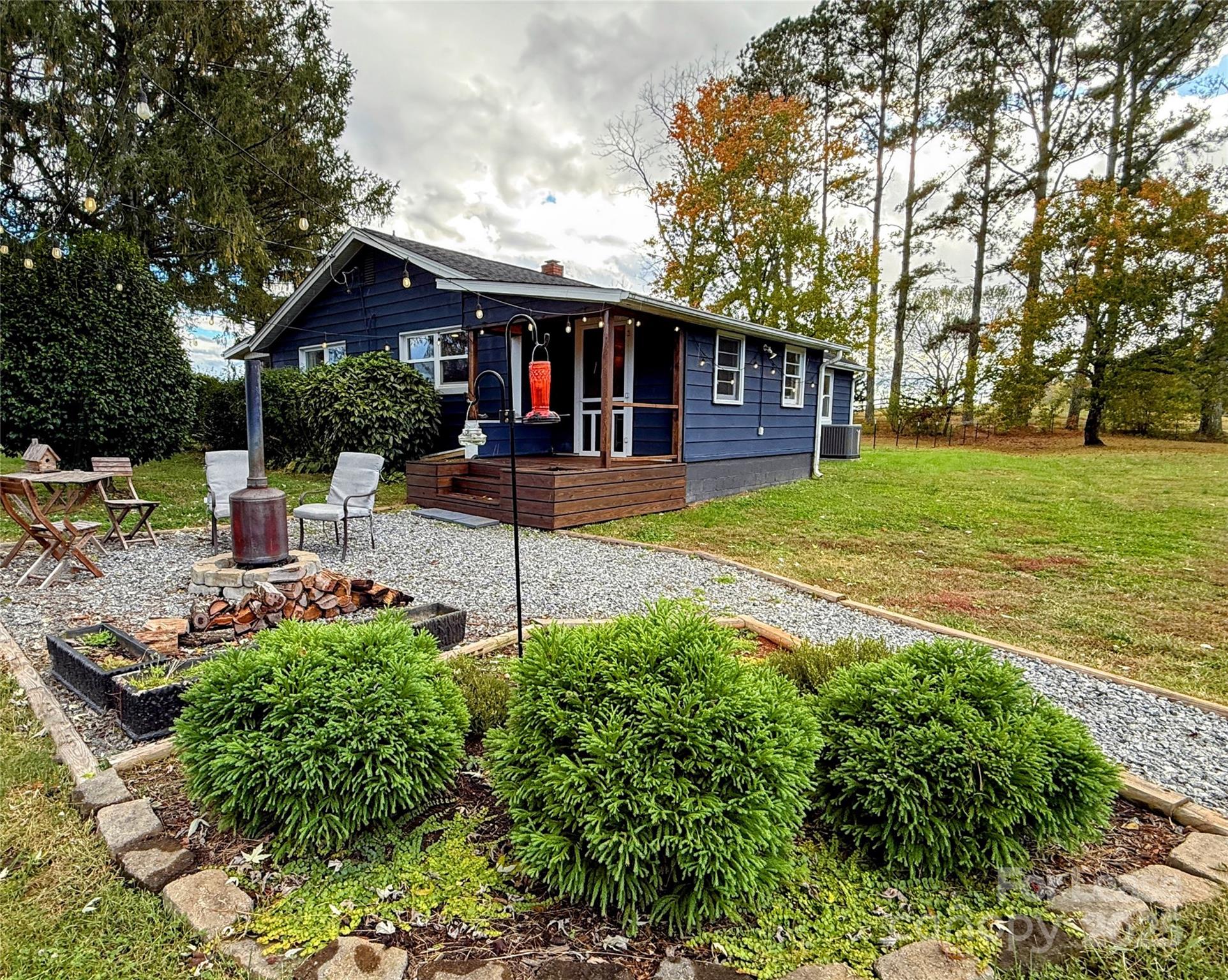 7135 Nc Highway Mill Spring, NC 28756 - Photo 1 of 28 a front view of a house with garden
