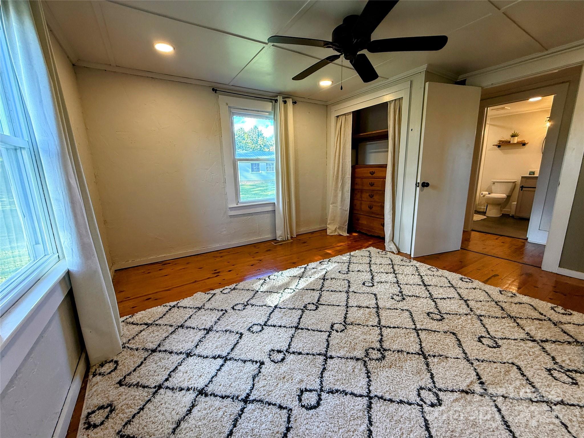 7135 Nc Highway Mill Spring, NC 28756 - Photo 15 of 28 a bedroom with a bed and a window