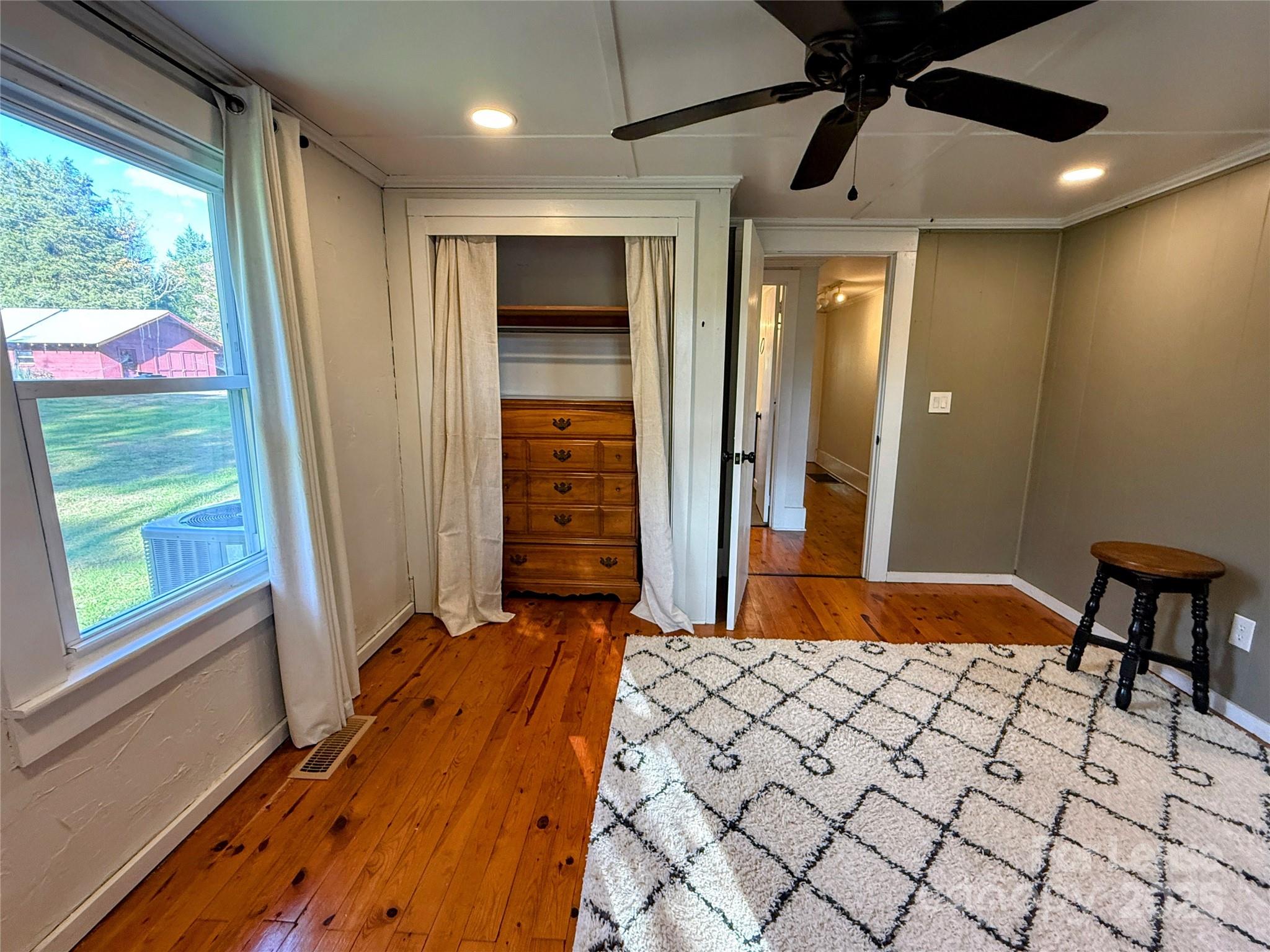 7135 Nc Highway Mill Spring, NC 28756 - Photo 16 of 28 a bedroom with a bed and a window