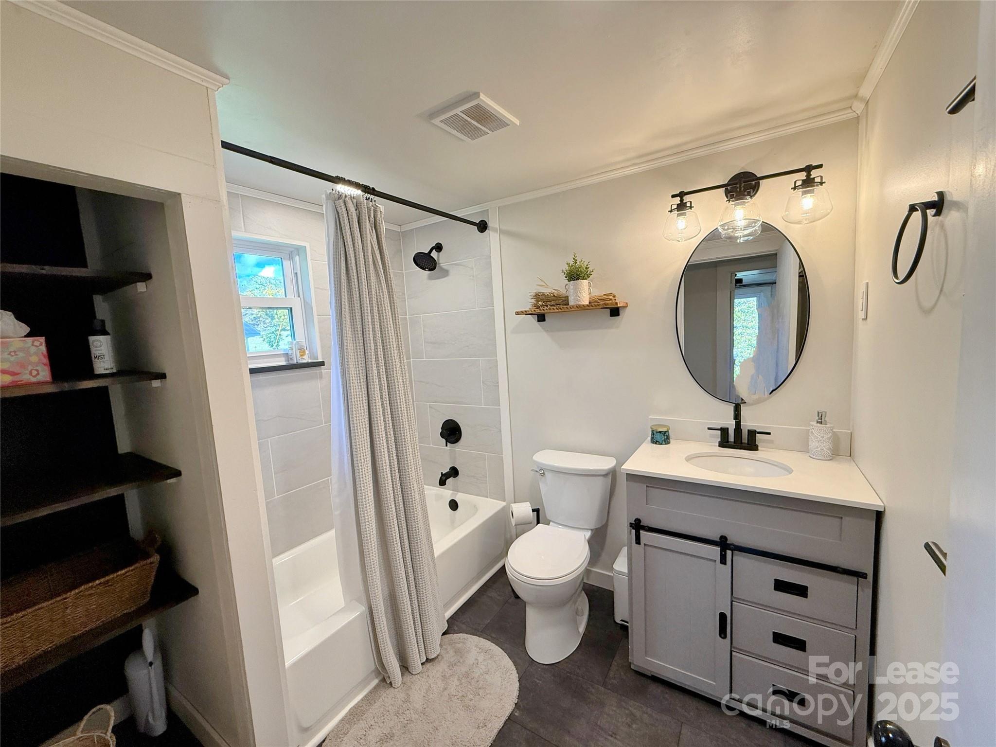 7135 Nc Highway Mill Spring, NC 28756 - Photo 18 of 28 a bathroom with a toilet sink and mirror