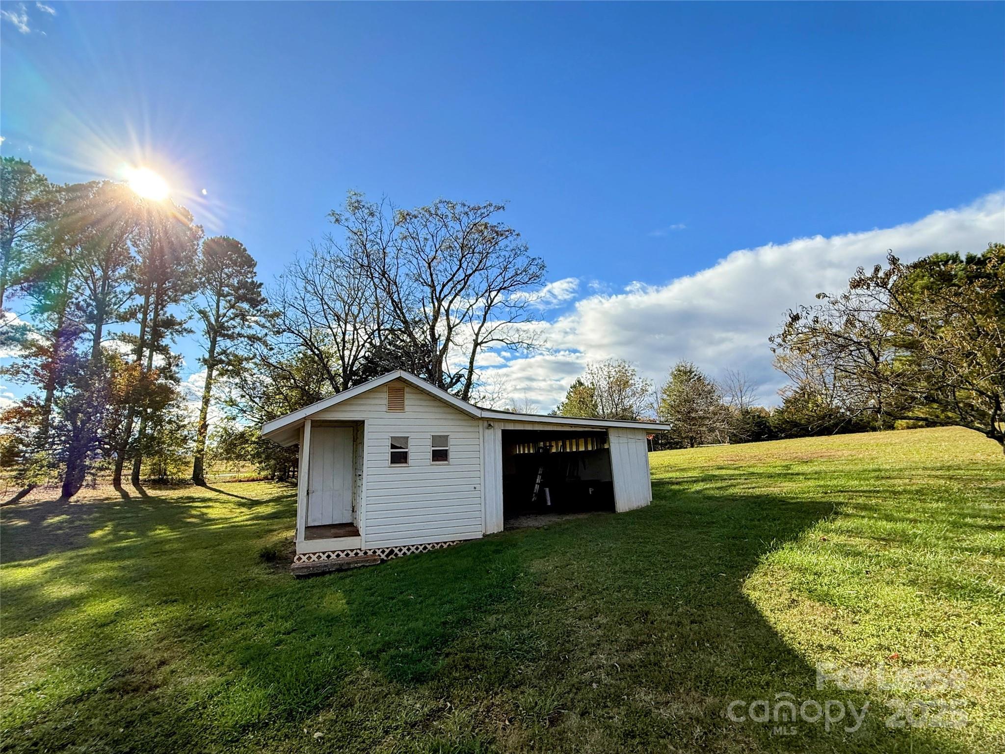 7135 Nc Highway Mill Spring, NC 28756 - Photo 26 of 28 a view of a backyard with plants and a garden