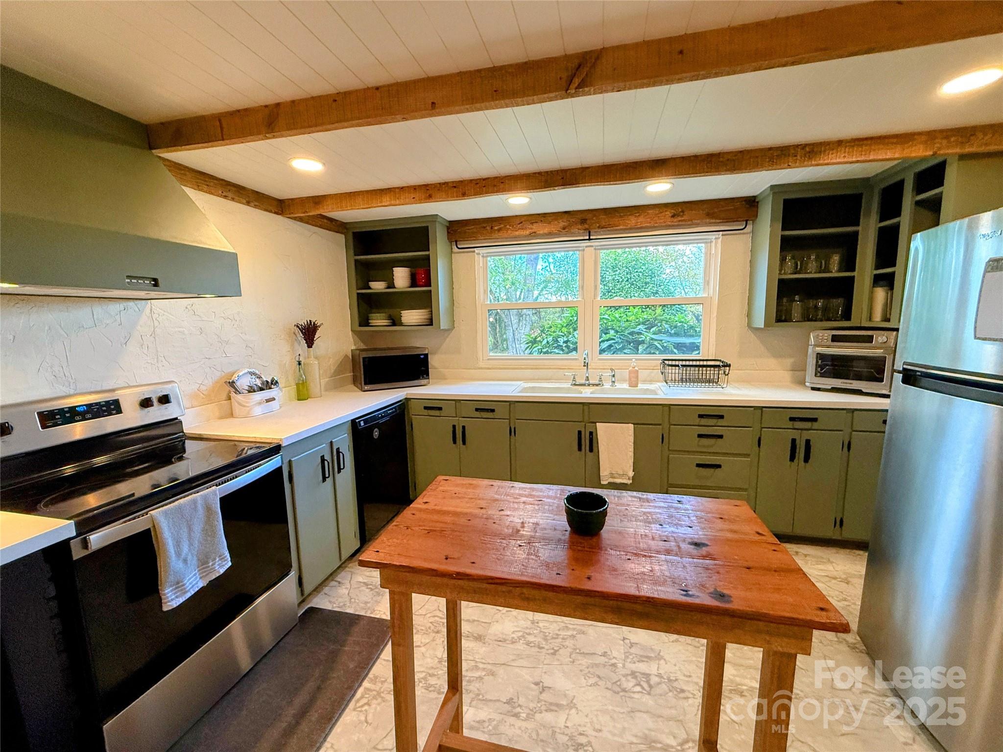 7135 Nc Highway Mill Spring, NC 28756 - Photo 9 of 28 a kitchen with kitchen island a sink stove and microwave