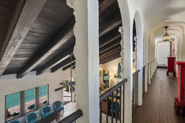 a view of staircase with lots of frames on wall