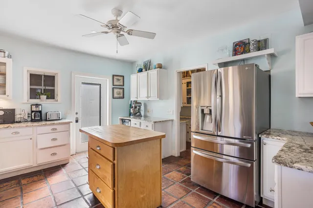 a kitchen with granite countertop a refrigerator oven a sink and dishwasher