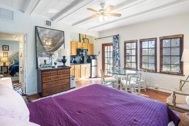 a bedroom with a bed a dresser and large mirror