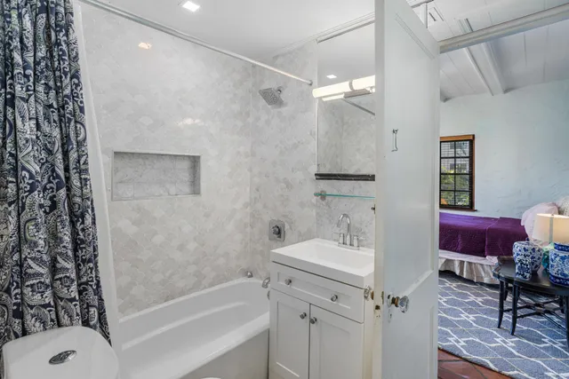 a bathroom with a bathtub a sink and a shower