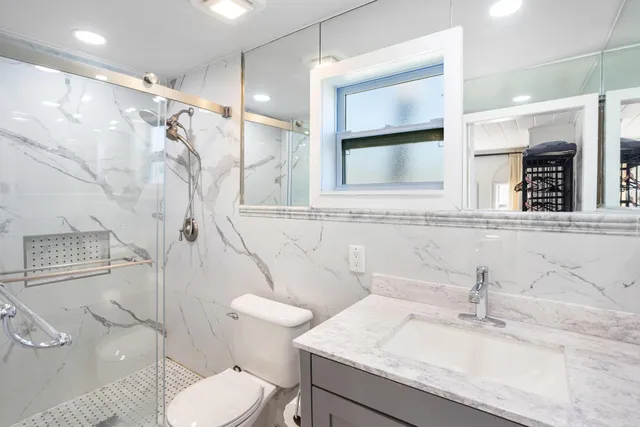 a bathroom with a sink toilet and shower