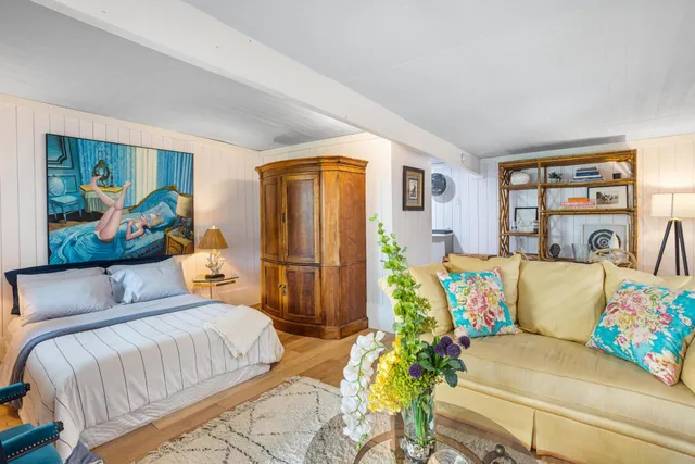 a bedroom with a bed and a couch