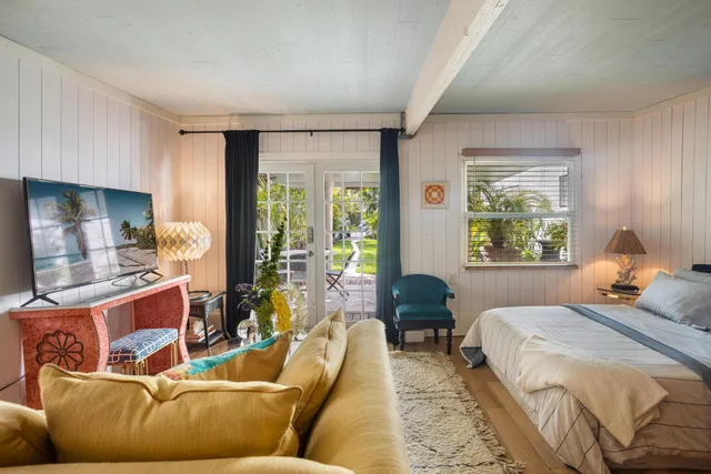 a bedroom with furniture and a large window