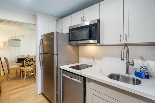 a kitchen with a refrigerator and a sink