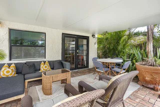 a living room with furniture and a potted plant