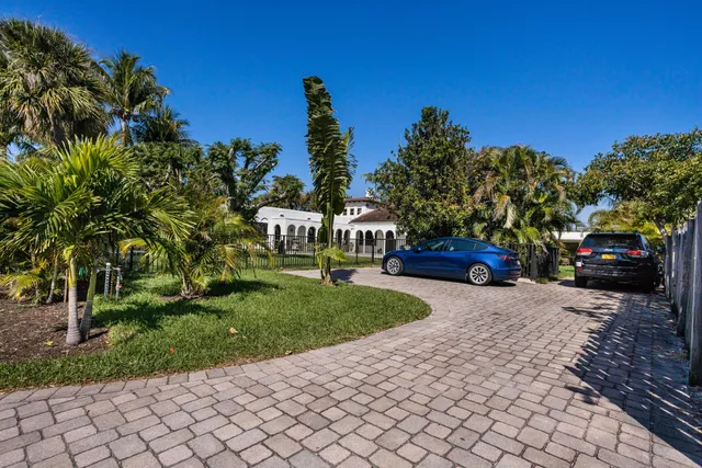 a view of a street with cars parked